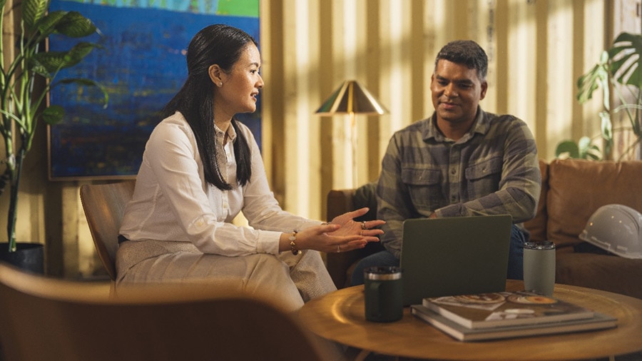 Two accountants sitting by a coffee table discussing the QuickBooks Accountant Affiliate program.