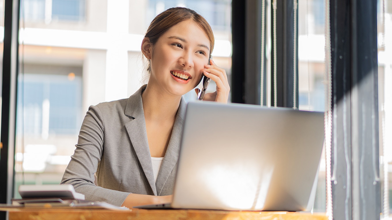 A person sitting at a desk with a laptop.